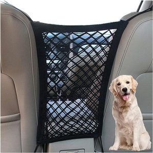 A white Bichon Frise dog sitting happily in the rear seat of a SUV, contained by a dual mesh dog car barrier.